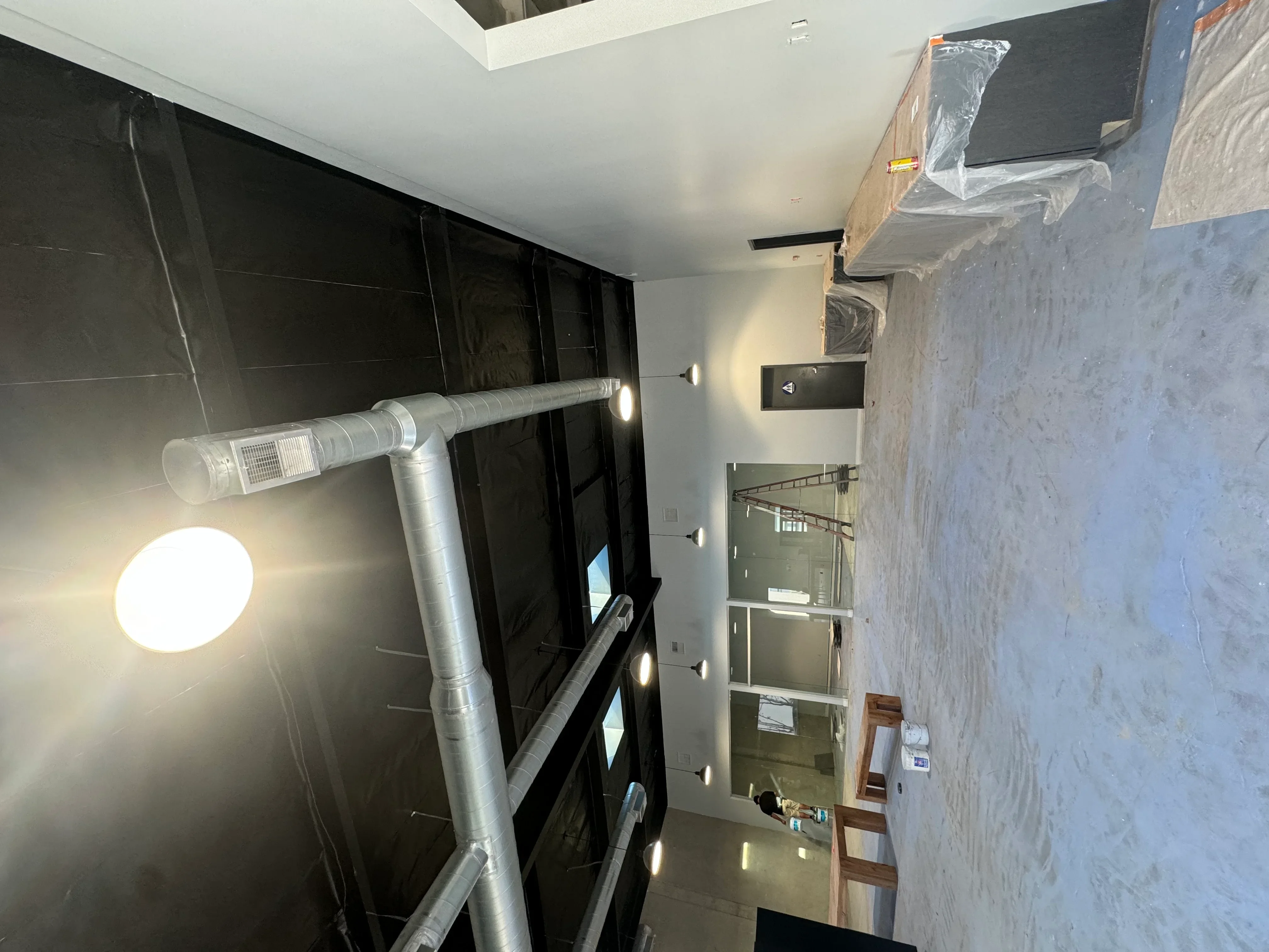 Bathroom interior with white drywall, metal ductwork, recessed lighting, and glass shower enclosure frame
