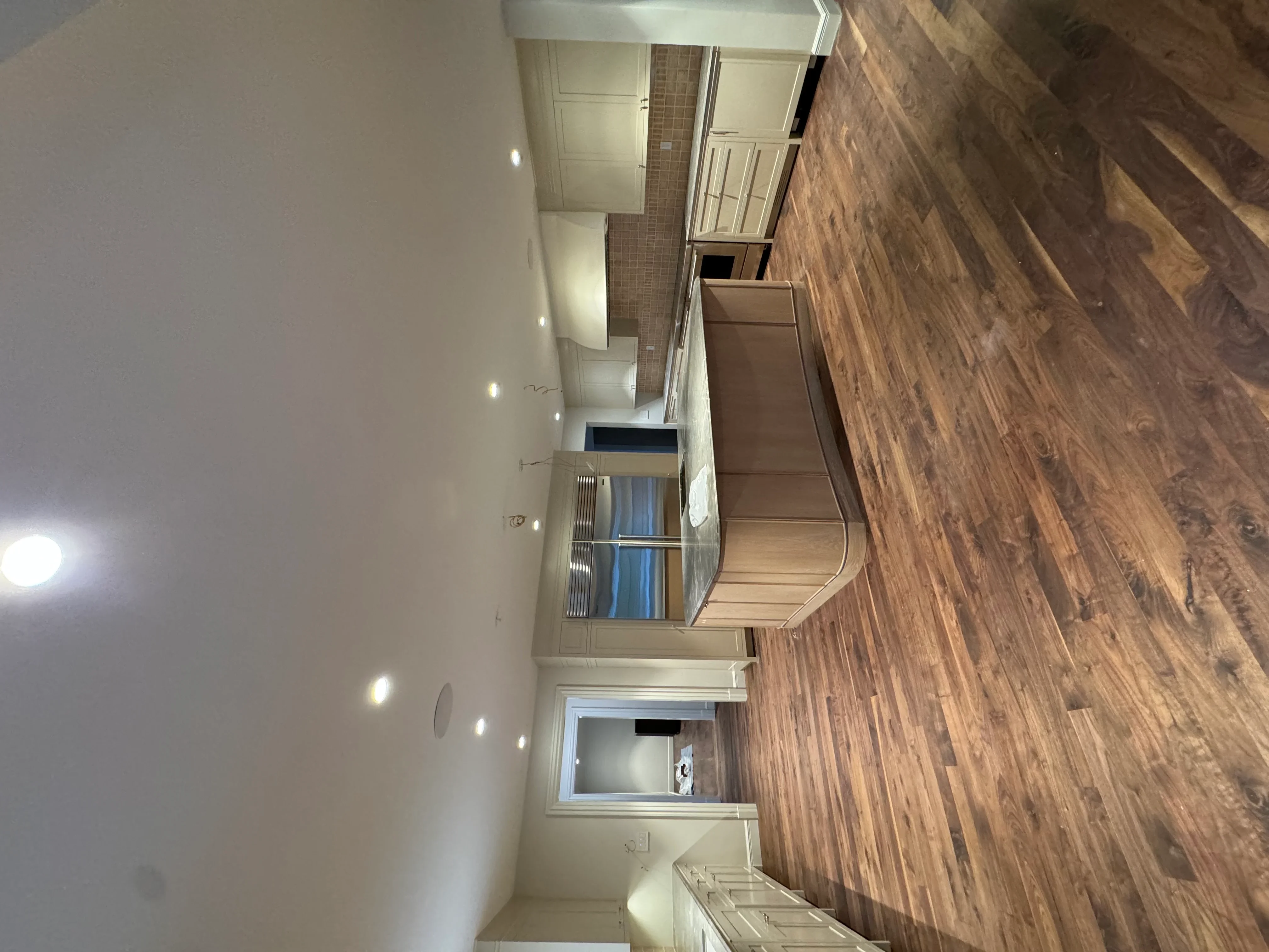 Kitchen and bathroom interior with neutral paint, recessed lighting, tile work, and hardwood flooring